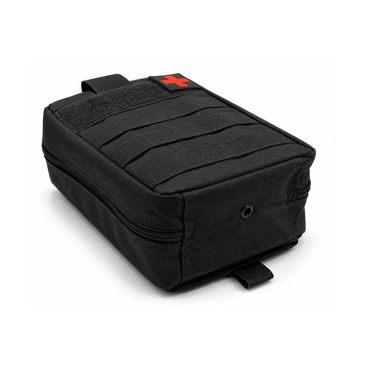 Black medical pouch laid flat to show the side profile, wraparound zipper, MOLLE webbing, hook &amp; loop panel with red cross patch, and metal drainage eyelet.