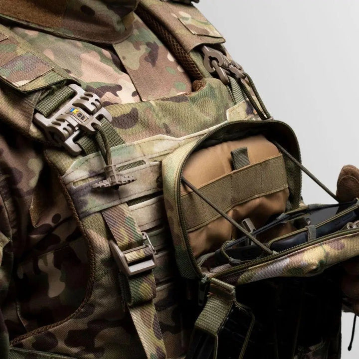 Tactical admin pouch mounted on plate carrier above rifle magazine pouches for quick-access storage of tactical essentials