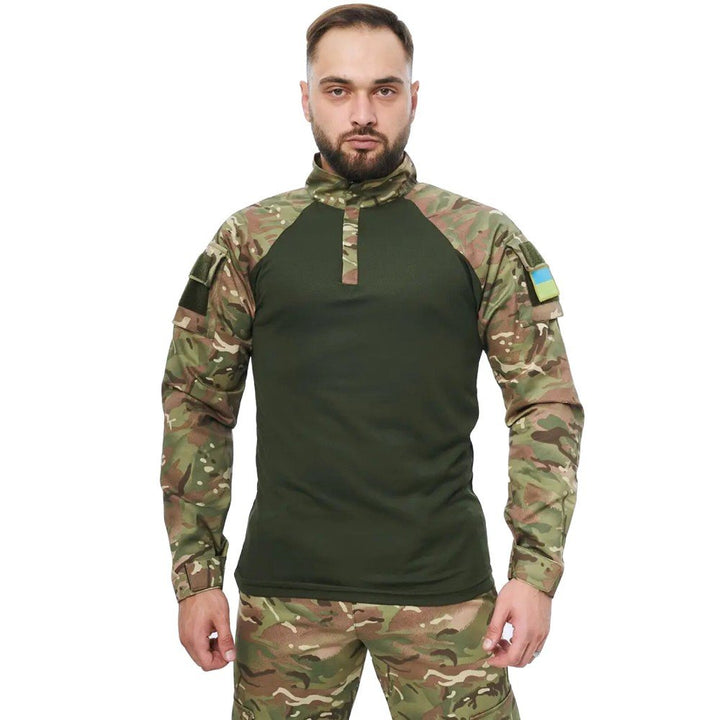 Front view of a man wearing a multicam UBACS shirt with a high collar and camo sleeves.