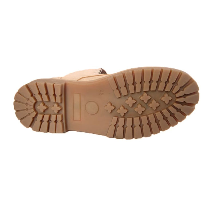 Underside view of beige combat boots showcasing the rugged tread for grip.