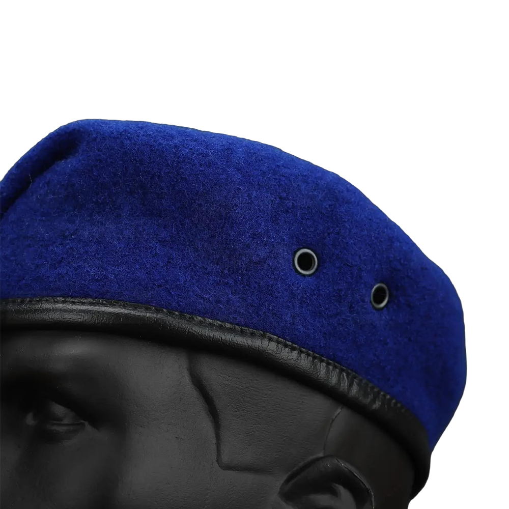 Close-up texture of royal blue wool military beret with dual metal ventilation eyelets