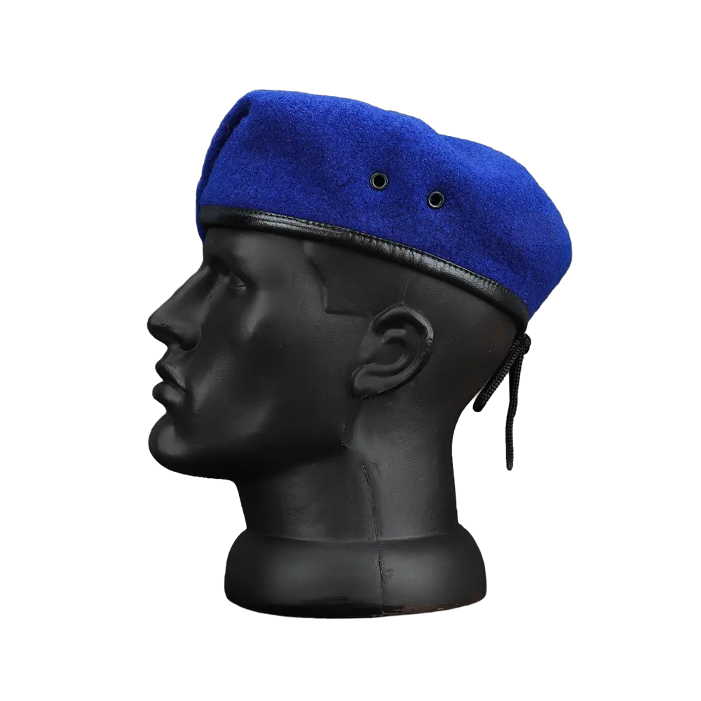 Side profile of men's royal blue wool beret with black leather trim and ear loops, displayed on a black mannequin head against a white background.