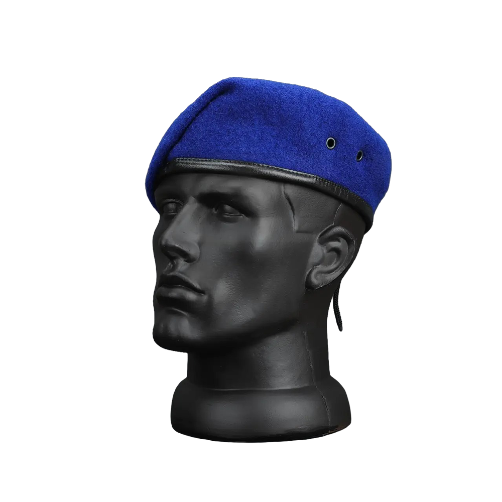 A royal blue wool beret with a black leather trim and chin strap, displayed on a black mannequin head against a white background.