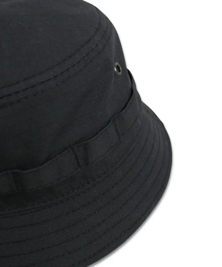Close-up of ripstop black panama hat with metal ventilation eyelets and rugged stitching