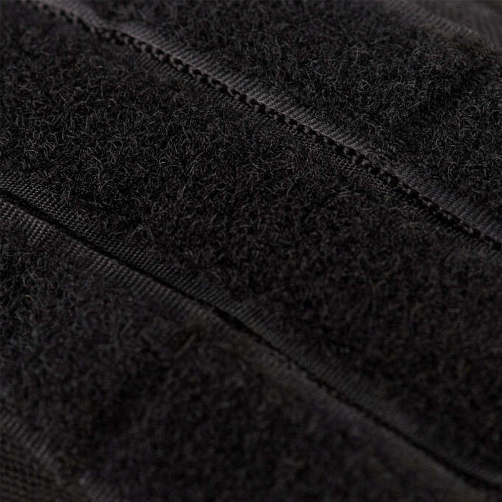 Close-up of the velcro patch area on a black tactical backpack.