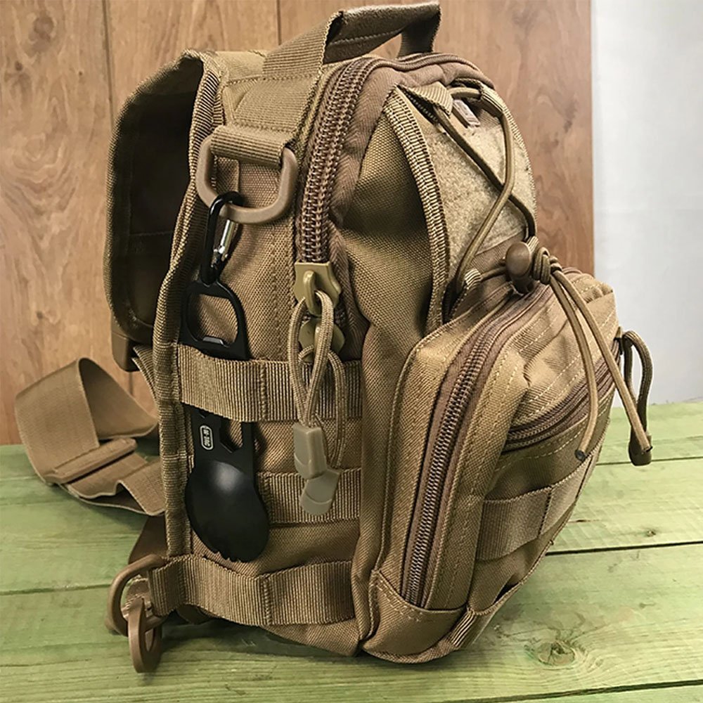 Compact coyote tactical chest bag with external carabiner and multi-compartment design.