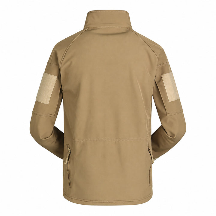 Coyote tactical softshell jacket shown from the back with high stand collar, sleeve hook &amp; loop panels, articulated sleeves, and two lower side zippers.