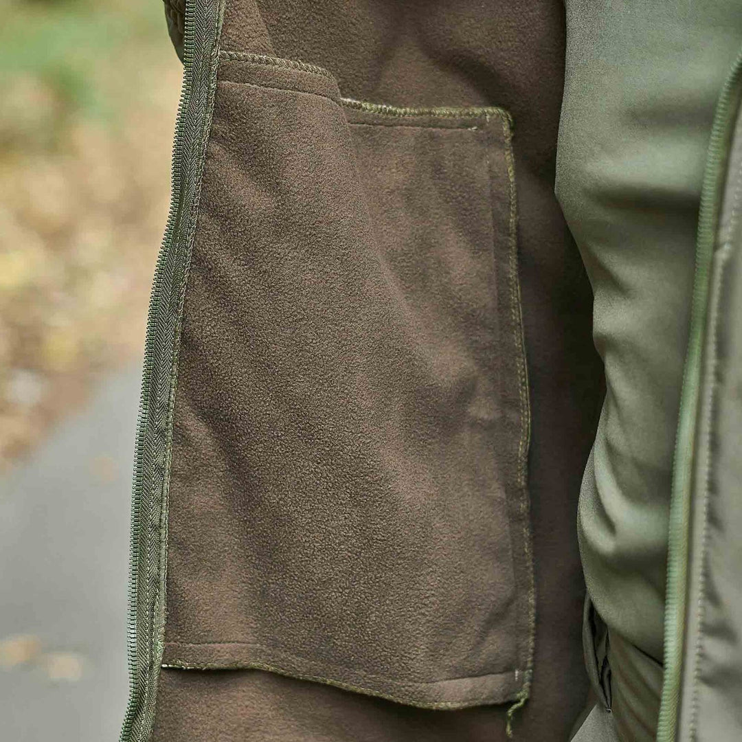 Close-up of the soft fleece lining inside an olive jacket, providing warmth and insulation.
