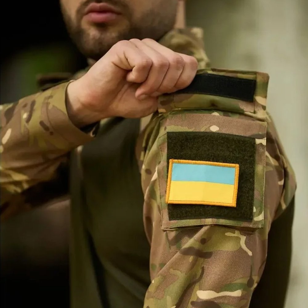 Close-up side view of a Ukrainian Army multicam UBACS shirt showing the sleeve pocket