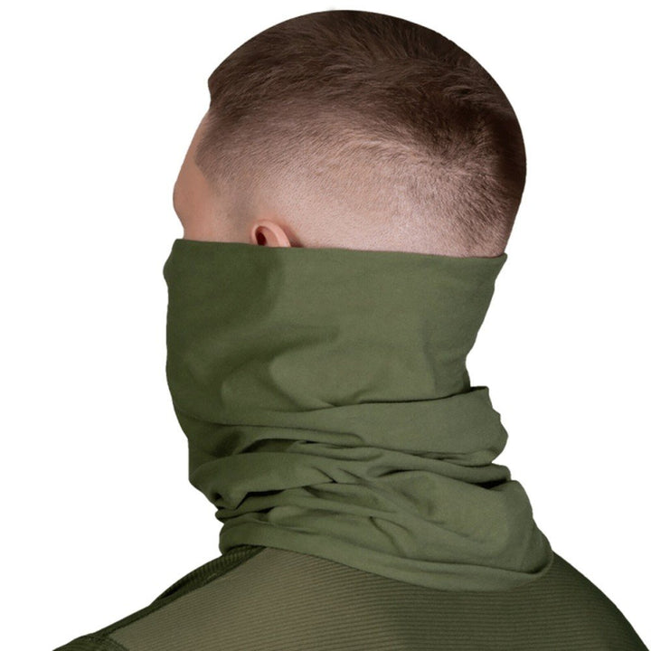Side view of a man wearing an olive tube scarf, providing full neck coverage.