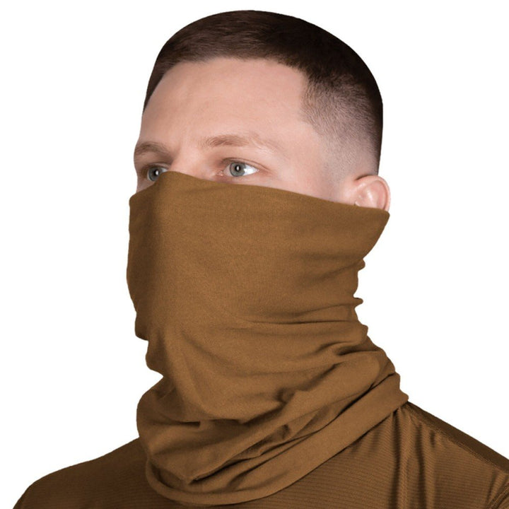 Man wearing a coyote-colored tactical tube scarf for outdoor and military use.
