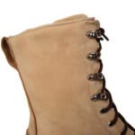 Close-up side view of beige tactical boots detailing the eyelets and stitching.