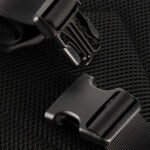 Close-up of a black tactical backpack's quick-release buckle.