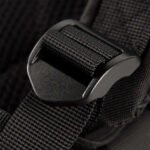 Close-up of a black tactical backpack's strap adjustment buckle.