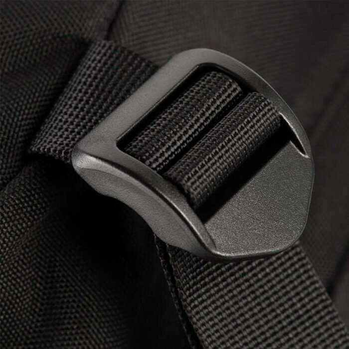 Close-up of the webbing and strap on a black tactical backpack.
