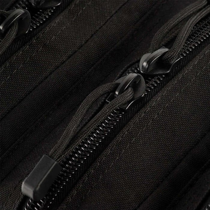 Close-up of the zipper and pull tabs on a black tactical backpack.