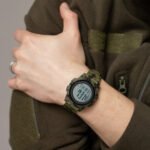 Man wearing a tactical wristwatch with a digital display