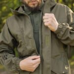 Upper body of an olive gorka military jacket with secure zipper closure and adjustable cuffs.