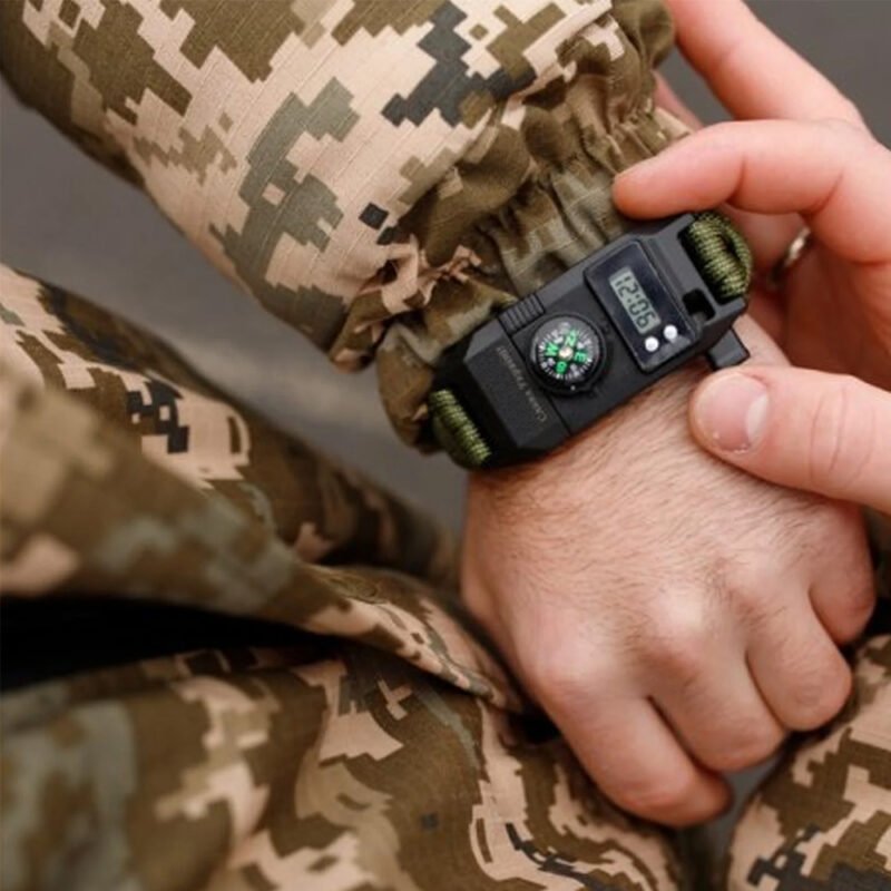 Military wristwatch with a built-in knife and compass worn on the wrist.