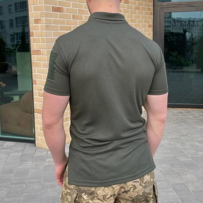 Back view of a man wearing a darker olive tactical polo shirt