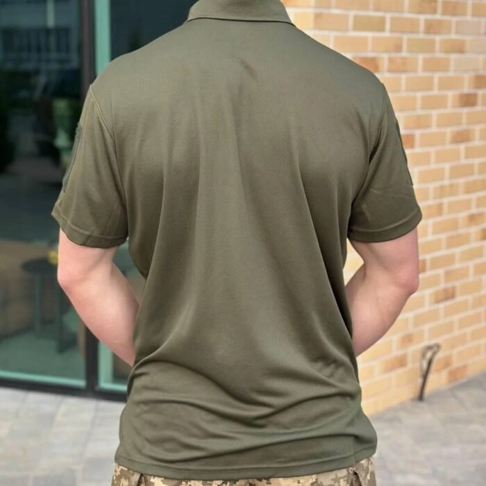 Back view of a man wearing a light olive tactical polo shirt.