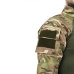 Back view of a man wearing a camouflage UBACS shirt with green torso and multi-cam sleeves.