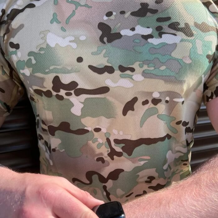 Close-up of a multicam t-shirt on a man, focusing on the pattern and fabric texture.