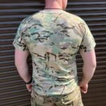 Back view of a man wearing a multicam t-shirt.