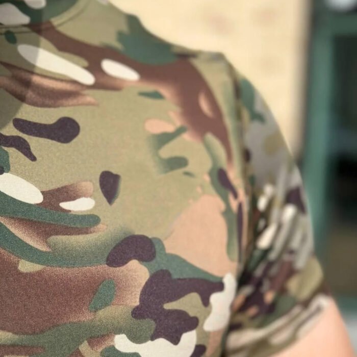 Close-up view of a multicam camouflage t-shirt on a man.