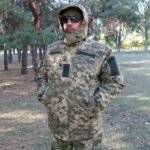 Ukrainian Army winter jacket in MM14 pixel camouflage with adjustable hood and fleece lining, front view.