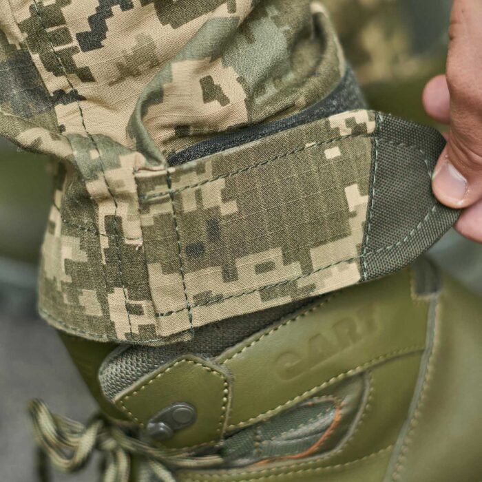 Velcro-adjustable leg straps on Ukrainian Army MM14 pixel camouflage pants.