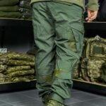 Back view of tactical khaki pants with multiple cargo pockets for practicality.