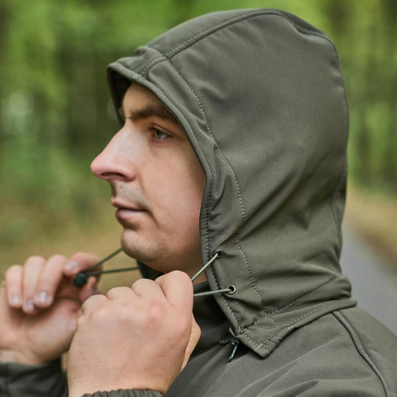 Side view of a men's tactical jacket with an adjustable hood and elastic cuffs for a custom fit.