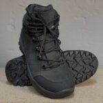 A front view of black tactical shoes, featuring heavy-duty leather construction, a reinforced toe cap, and a rugged sole for airsoft, hiking, and military operations.