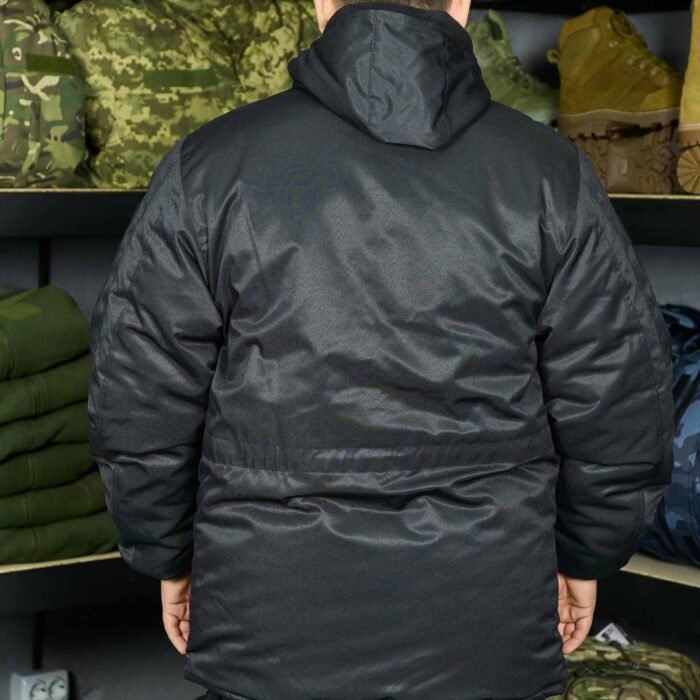 Close-up of a tactical pocket on a black military jacket, providing secure storage for essential gear.