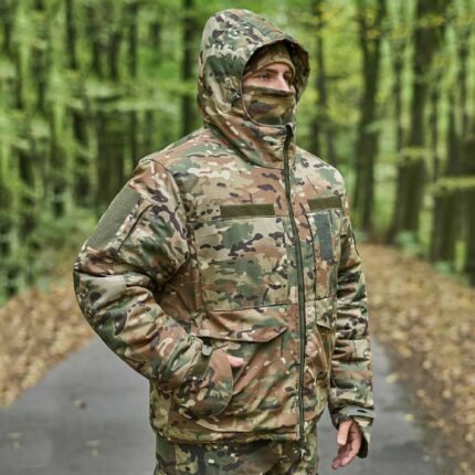 A man wearing a multicam military jacket, featuring multiple pockets, insulation, and a tactical design.