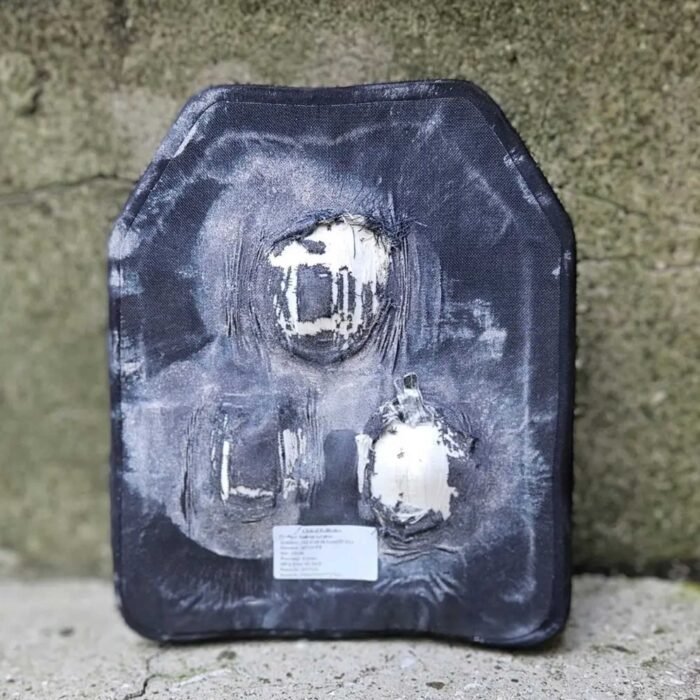 Damaged ballistic plate showing bullet impacts after laboratory test