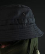 Front view of black bush hat with MOLLE and chin strap worn with face mask