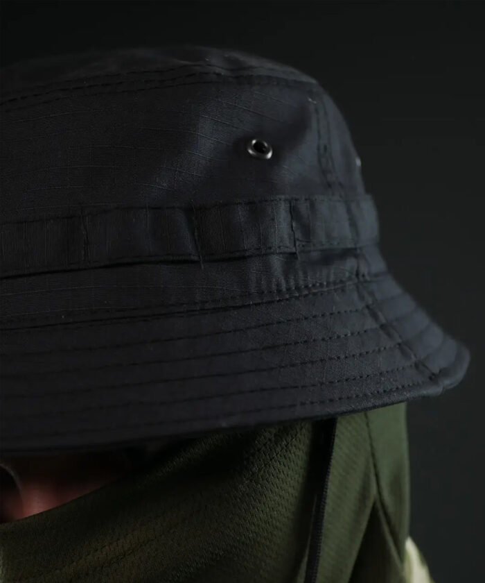 Front view of black bush hat with MOLLE and chin strap worn with face mask