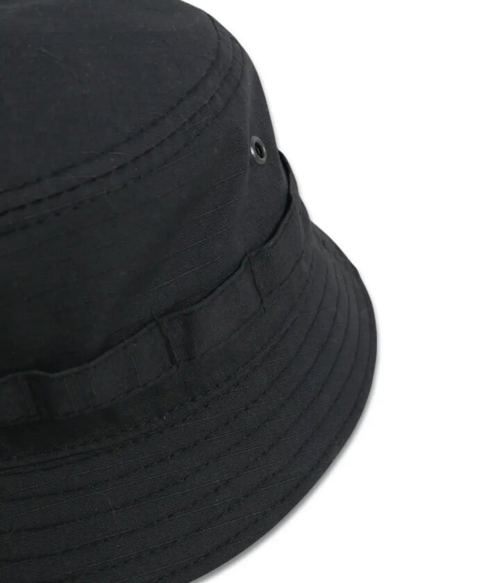 Close-up of ripstop black panama hat with metal ventilation eyelets and rugged stitching