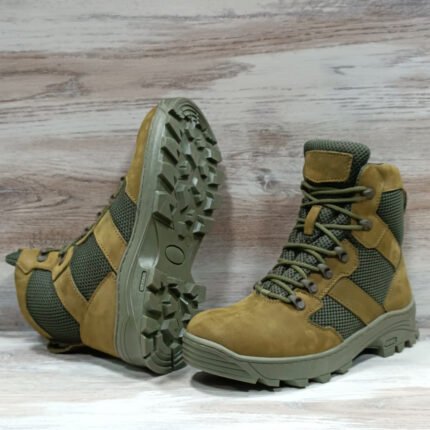 Olive green lightweight tactical summer boots with leather and 3D mesh panels, featuring high-lacing and rugged NATO-style trekking sole on wooden background.